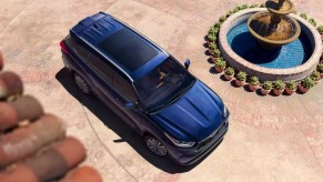 An aerial view of a blue 2023 Toyota Highlander midsize SUV parked near a fountain.