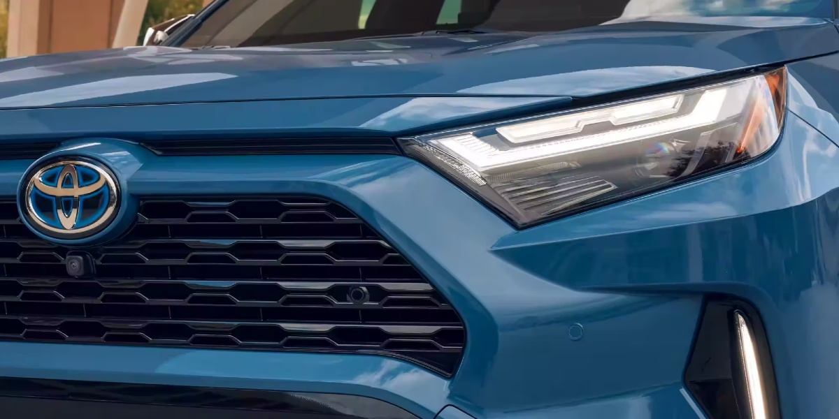 The front of a blue 2024 Toyota RAV4 Hybrid small hybrid SUV/