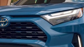 The front of a blue 2024 Toyota RAV4 Hybrid small hybrid SUV/