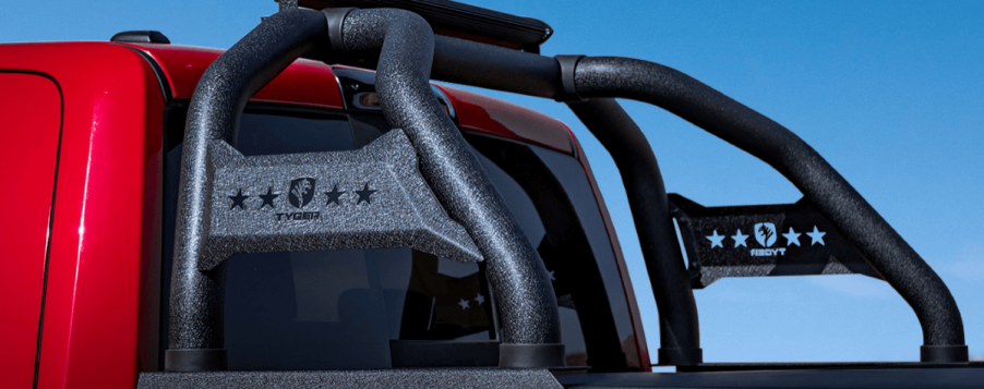 A red pickup truck fitted with a Tyger sports bar mount on its bed