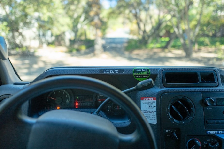 The interior, steering wheel, and automatic shift lever in a U-Haul rental truck.