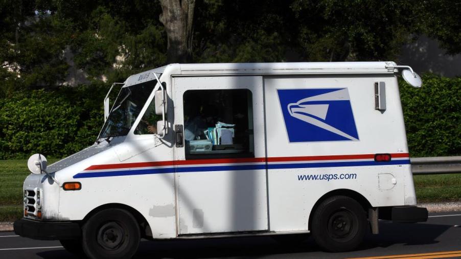 A USPS Grumman LLV delivery truck being driven by a mail carrier in Orlando, Florida