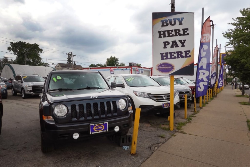 A used car lot shows off a stock of SUVs and cars.