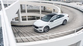 A white Volkswagen Jetta driving down a ramp. The Jetta recall affects 2019 and 2020 models.