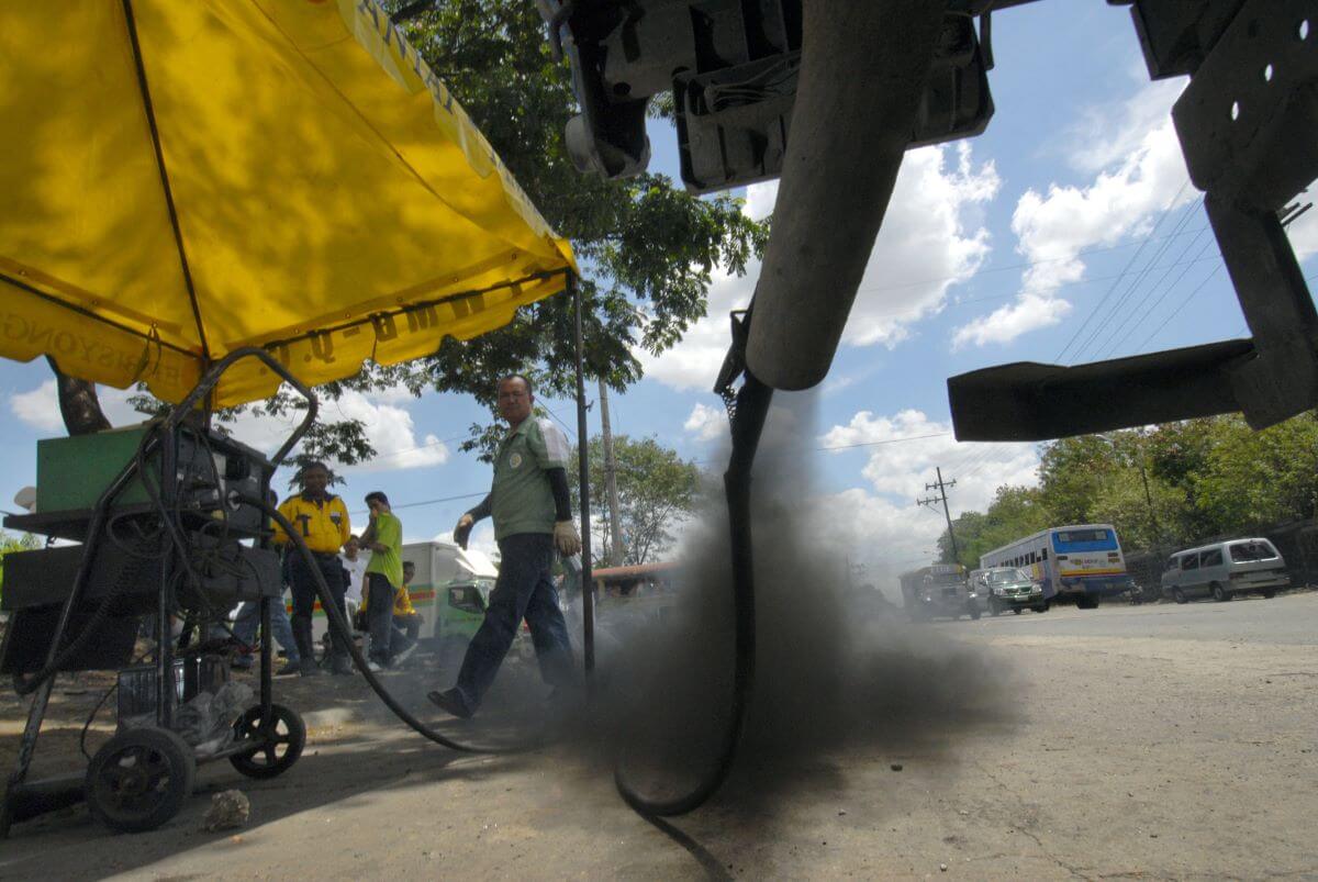 A truck in the Philippines emitting black smoke from its exhaust system during government testing