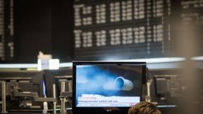 The exhaust pipe of a diesel vehicle emitting blue smoke shown on a computer monitor at a German stock exchange