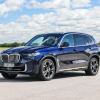 A promotional image of the redesigned BMW X5 midsize luxury SUV model on an asphalt lot