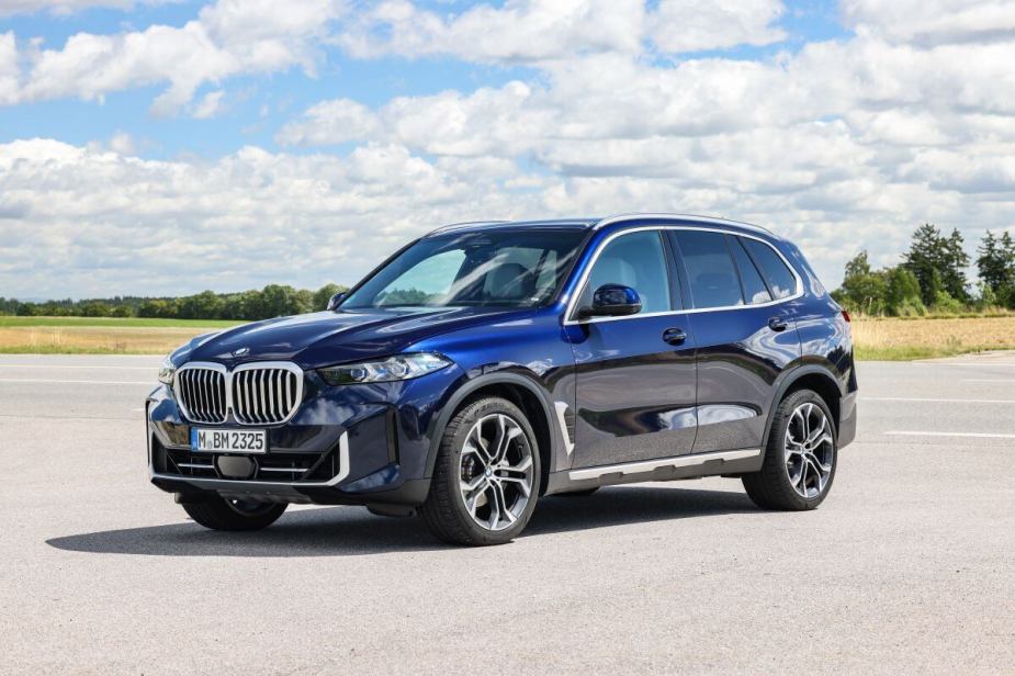 A promotional image of the redesigned BMW X5 midsize luxury SUV model on an asphalt lot