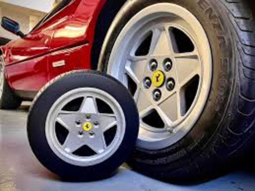 Ferrari mooncake box and pastries next to Ferrari wheel