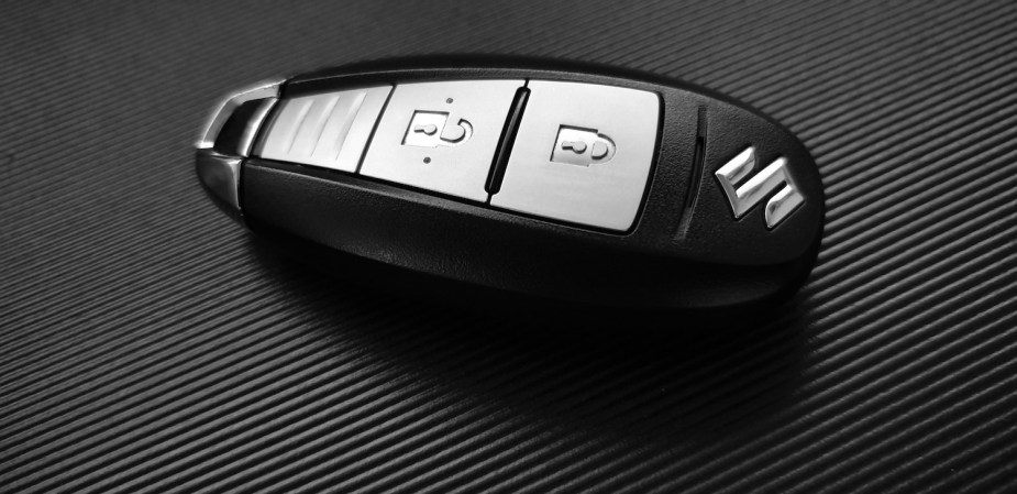 A silver and black wireless key fob for unlocking a car.