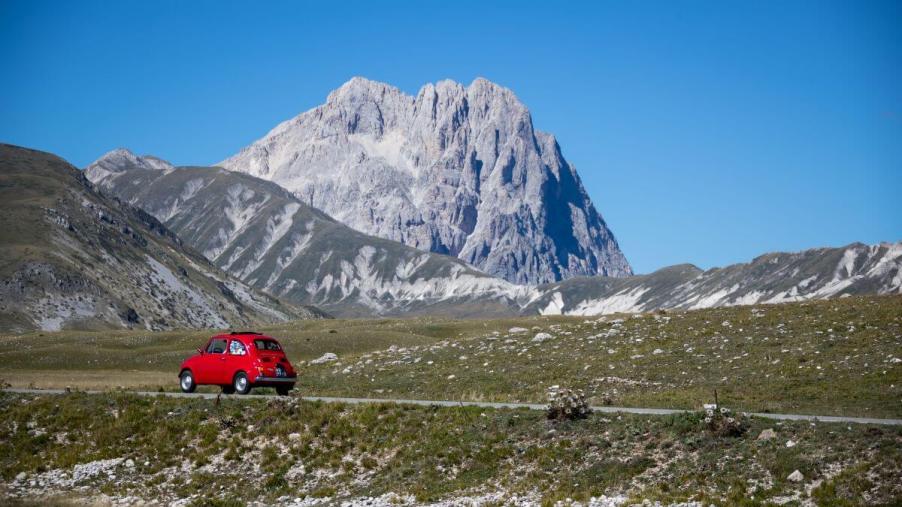 A singular Fiat 500 model driving near the Apennine Mountains in Campo Imperatore, Italy