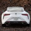 A rear shot of the trunk, bumper, and taillights on a 2024 Lexus LC 500 grand tourer parked on clumps of dirt