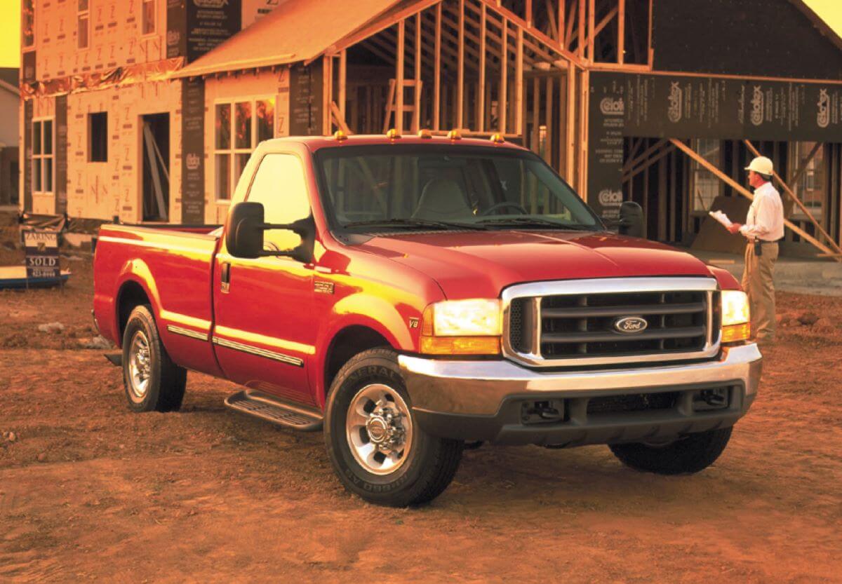 A 1999 Ford F-250 Super Duty heavy-duty pickup truck with the 7.3L diesel Power Stroke engine parked on dirt
