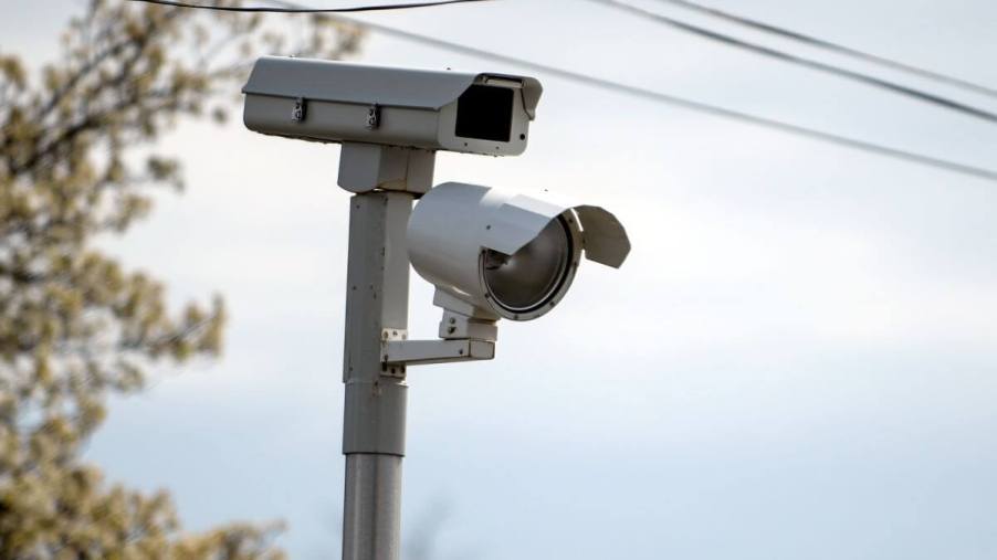 A red light camera on a corner catching speeding driver in Commack, New York on Long Island