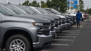 A row of Chevrolet Silverado pickup trucks on a used car lot in Ohio, the cheapest state to buy used cars in America.