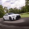 A 2024 Lexus IS 350 F Sport compact executive car model cornering in a park