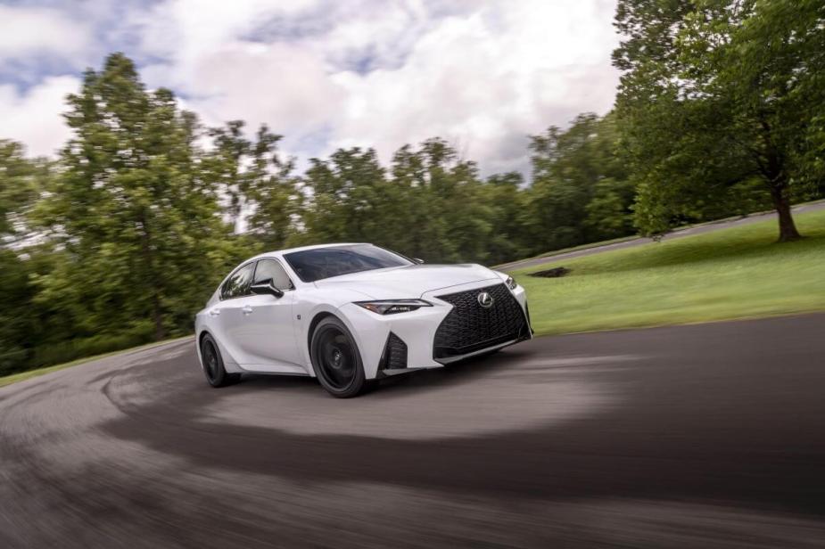 A 2024 Lexus IS 350 F Sport compact executive car model cornering in a park