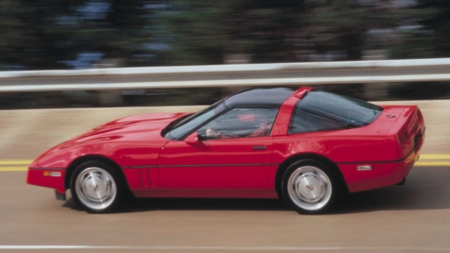 A red C4 Corvette ZR-1 stretches its Lotus and GM-derived V8 car stamina as it flies down a banked stretch of road.