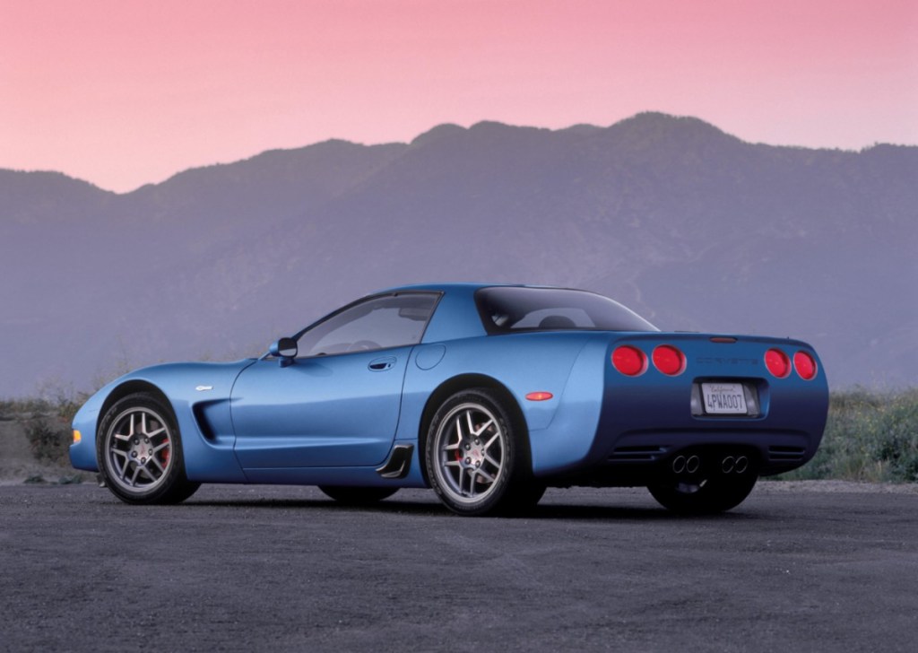 A blue C5 Corvette Z06 sits under a sunset.