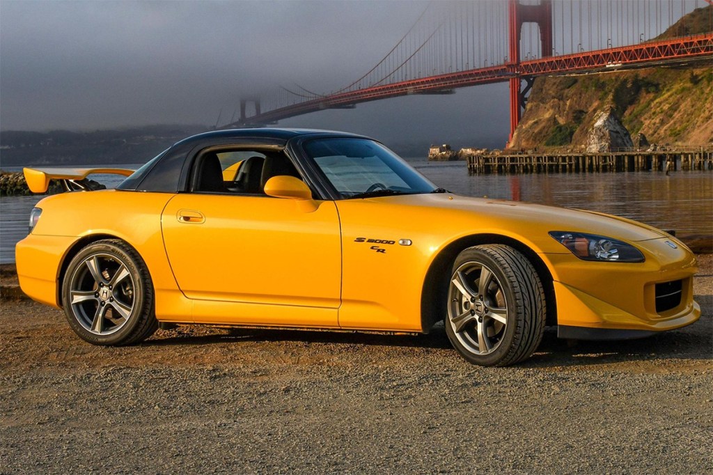 Yellow 2009 Honda S2000 CR parked in front of the golden gate bridge
