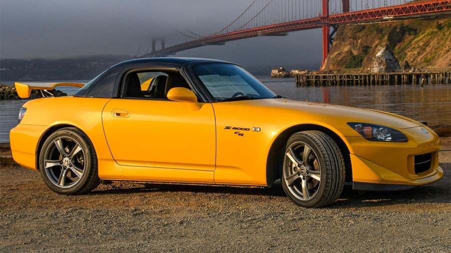 Yellow 2009 Honda S2000 CR parked in front of the golden gate bridge