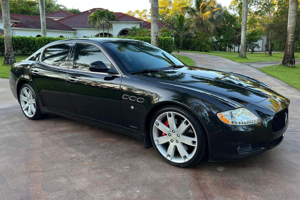 Side view of a 2009 Maserati QuattroPorte in black that sold for incredibly cheap on Cars and Bids