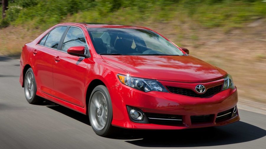 A red 2014 Toyota Camry on display.