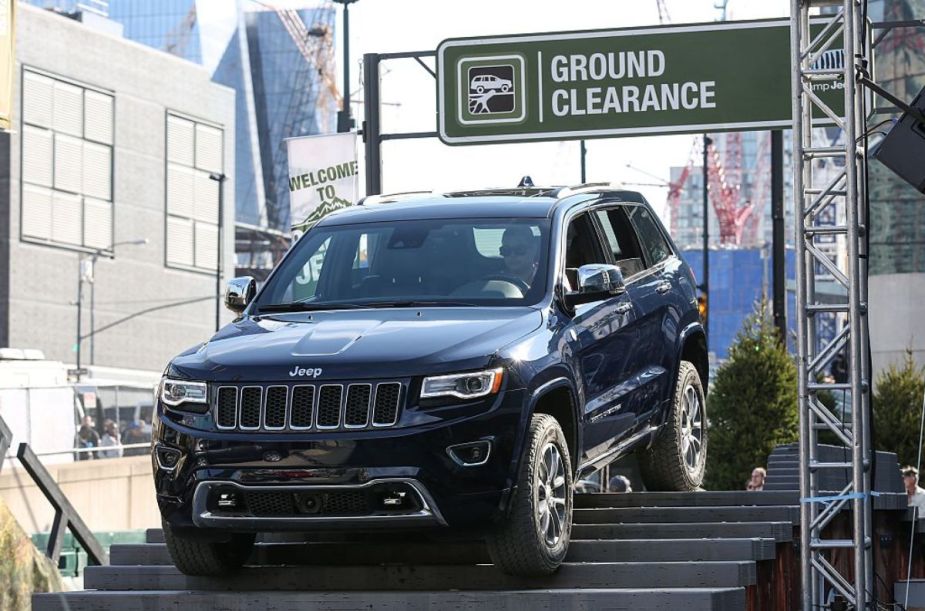 A 2016 Jeep Grand Cherokee doing an demonstration at an auto show.
