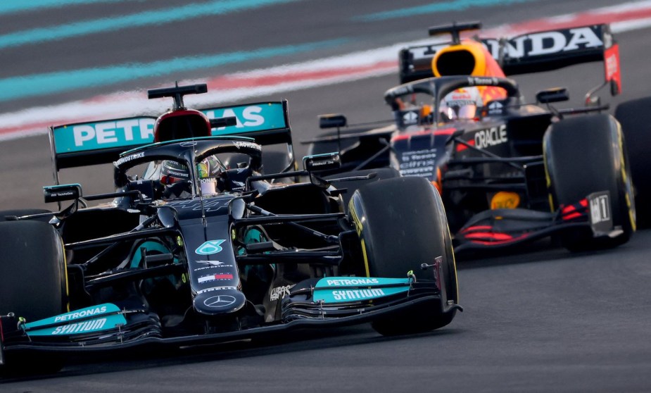 Lewis Hamilton's green Formula 1 Mercedes leads Max Verstrappen's Red Bull Honda car during the 2021 Abu Dhabi Grand Prix