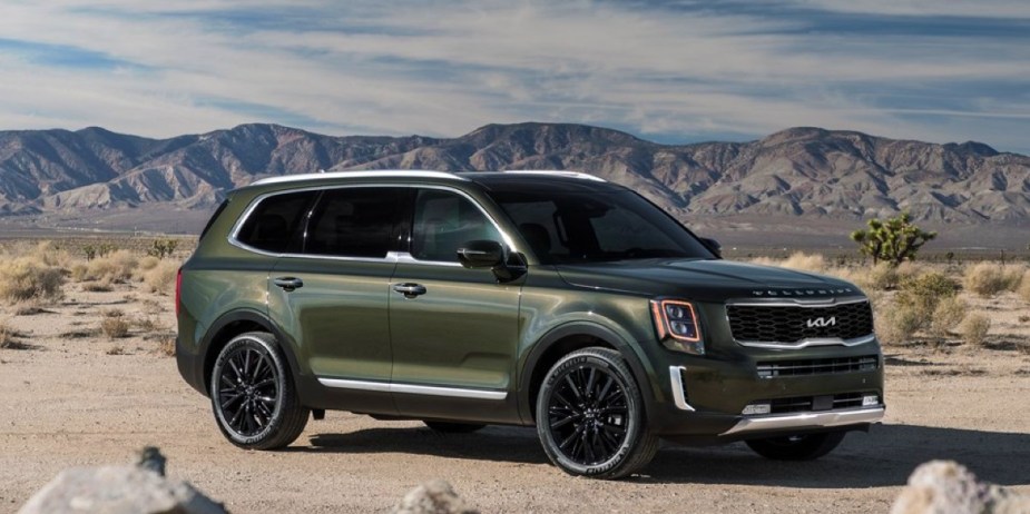 A green 2022 Kia Telluride midsize SUV is parked outdoors.