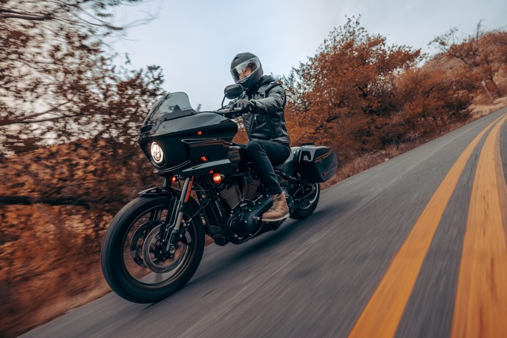 A 2023 Harley-Davidson Low Rider ST, a cruiser motorcycle like the Street Bob 114, does its best to corner on a autumn ride.