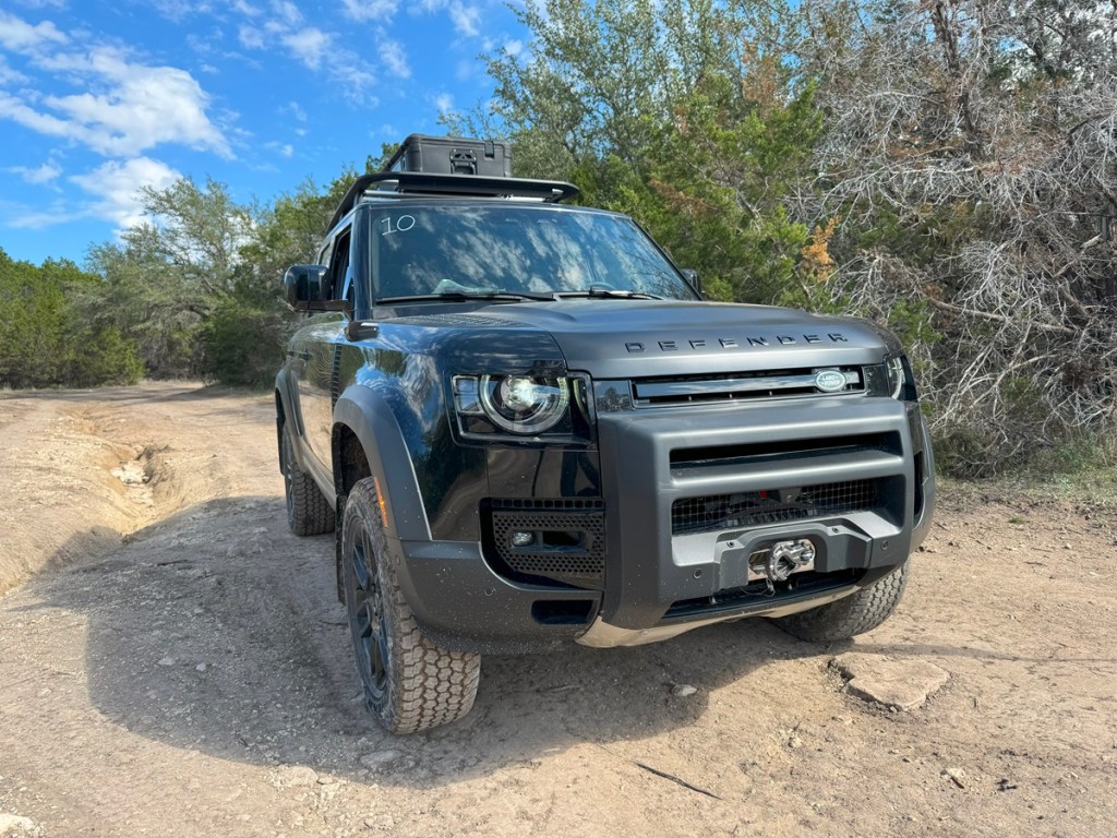 2023 Land Rover Defender 130 Trophy Edition off-roading on a dirt trail 