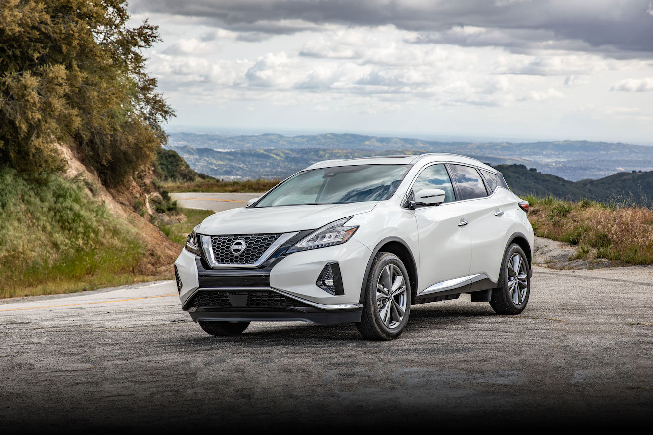 A white 2023 Nissan Murano driving on a mountain. Nissan Murano sales are lagging this year.