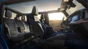 2023 Ford Bronco interior view with top off roll bars at sunset