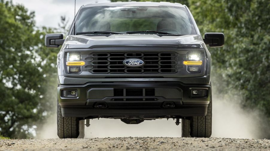 The 2024 Ford F-150 off-roading on a dirt trail