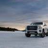 2023 GMC Yukon AT4 driver front 7/8 view on snow.