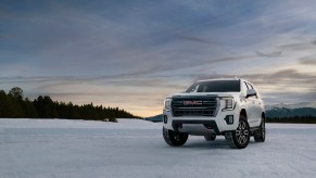 2023 GMC Yukon AT4 driver front 7/8 view on snow.