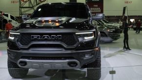 A black 2024 Ram 1500 TRX on display at an auto show.