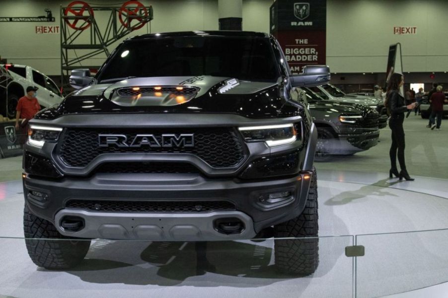 A black 2024 Ram 1500 TRX on display at an auto show.