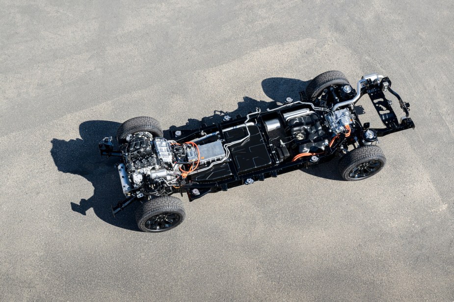 The exposed powertrain of a Ramcharger pickup truck which has a Ram REV electric vehicle chassis and a V6 range-extender.
