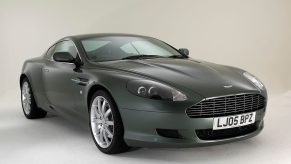 An Aston Martin DB9 GT car, not unlike the DB7 in Johnny English, shows off its touring car lines on a stage.