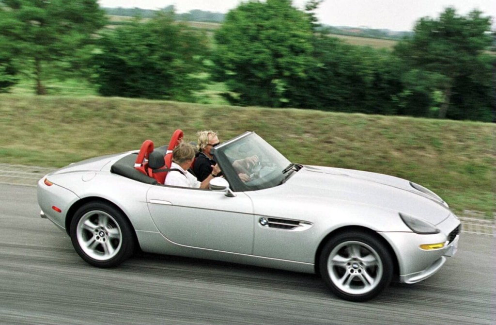 A silver BMW Z8 Roadster, like the one in the Matthew Perry collection, drives on an open road.