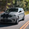 Gray 2024 Dodge Durango driving down a road. There are plenty of reasons to buy a 2024 Dodge Durango.