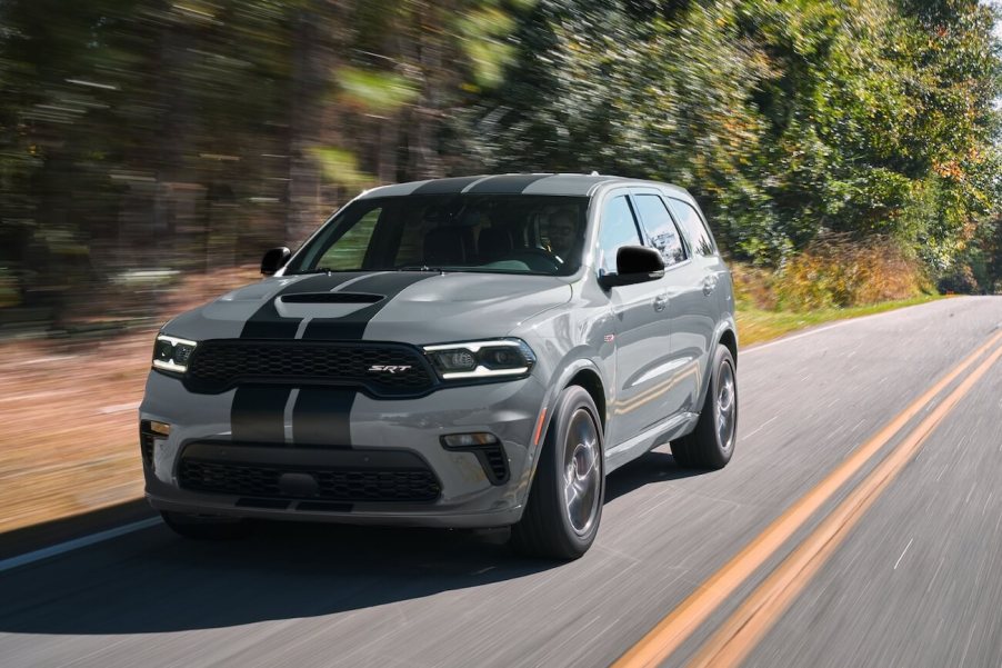 Gray 2024 Dodge Durango driving down a road. There are plenty of reasons to buy a 2024 Dodge Durango.