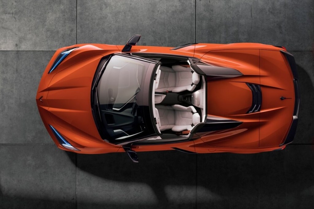 An orange C8 Chevrolet Corvette Convertible shows off its retractable hardtop.