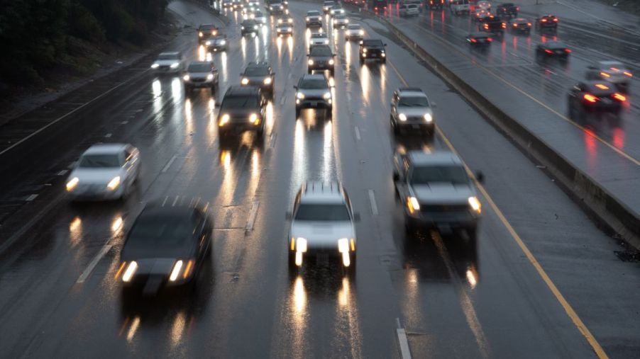 Cars cruising on the highway on a rainy day.