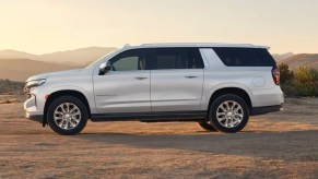 A white 2023 Chevrolet Suburban full-size SUV is parked.