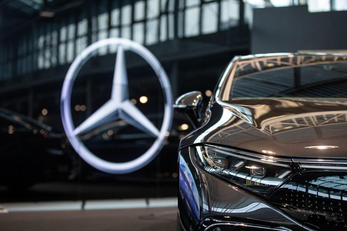 The Mercedes-Benz logo on the glass of a Daimler-AG showroom of MB luxury cars in Berlin, Germany