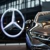 The Mercedes-Benz logo on the glass of a Daimler-AG showroom of MB luxury cars in Berlin, Germany
