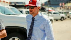 Dale Earnhardt Jr. wears a suit and tie in a parking lot